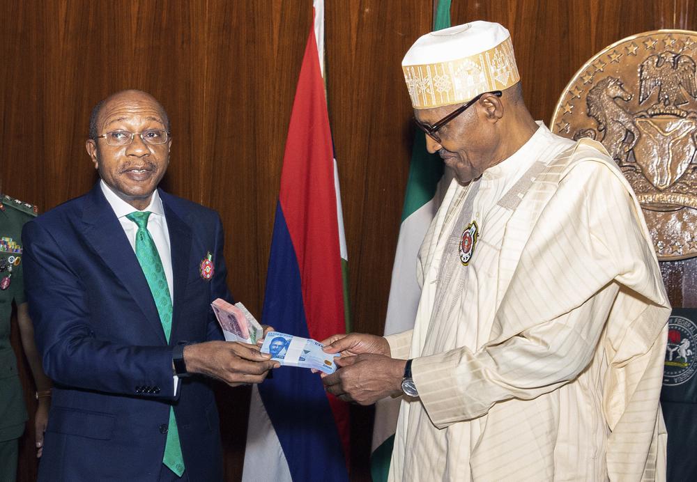 محافظ النبنك المركزي يقدم أوراق نقدية مصممة حديثا للرئيس النيجيري (AP)